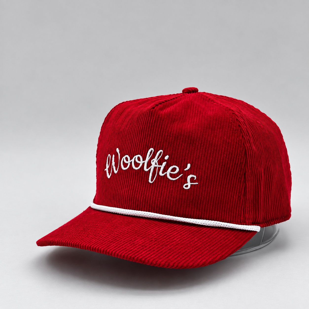 Red corduroy Woolfie’s cap with white embroidery and rope trim