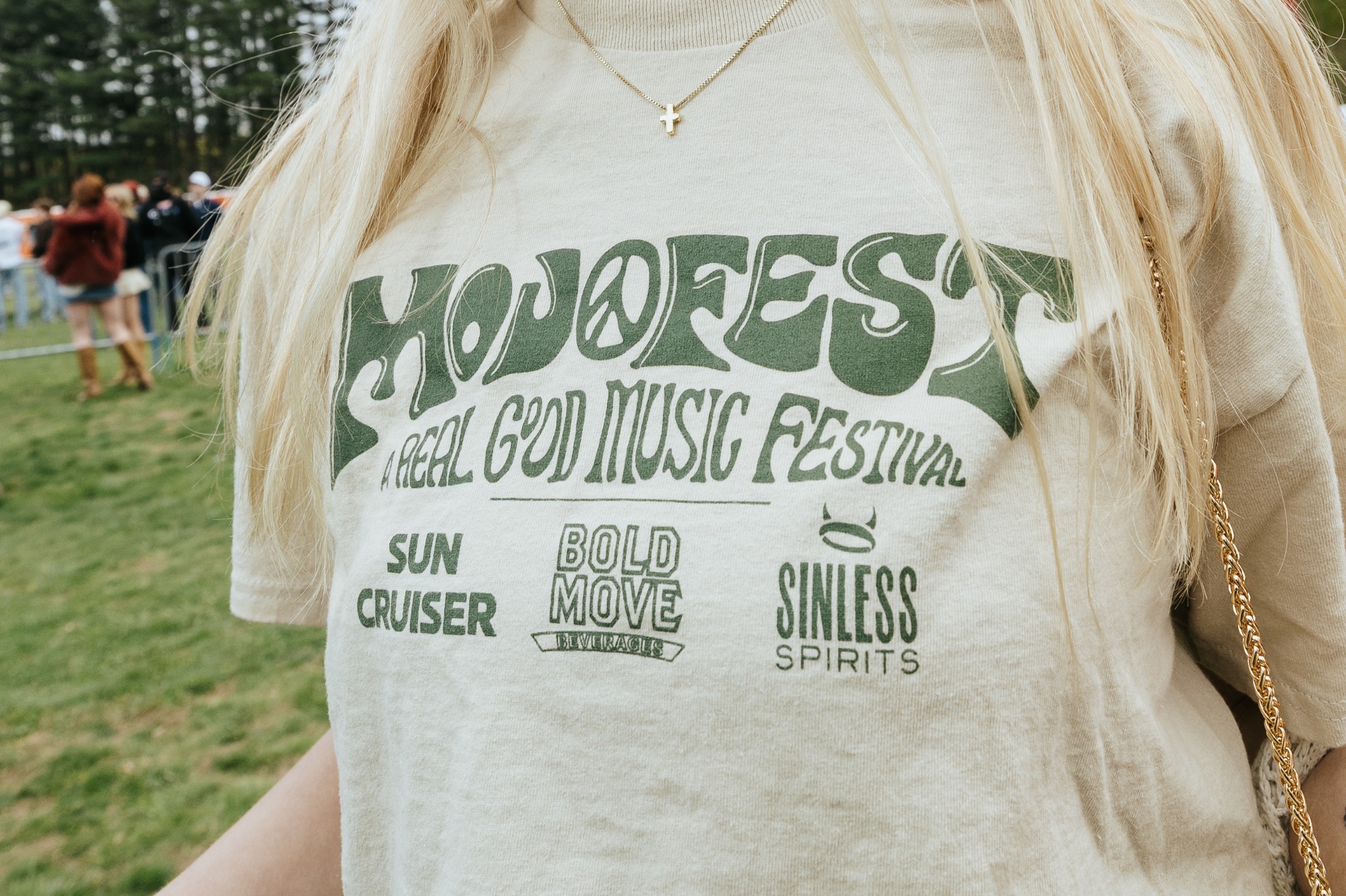 Close-up of green MOJOFEST artwork printed on a cream shirt