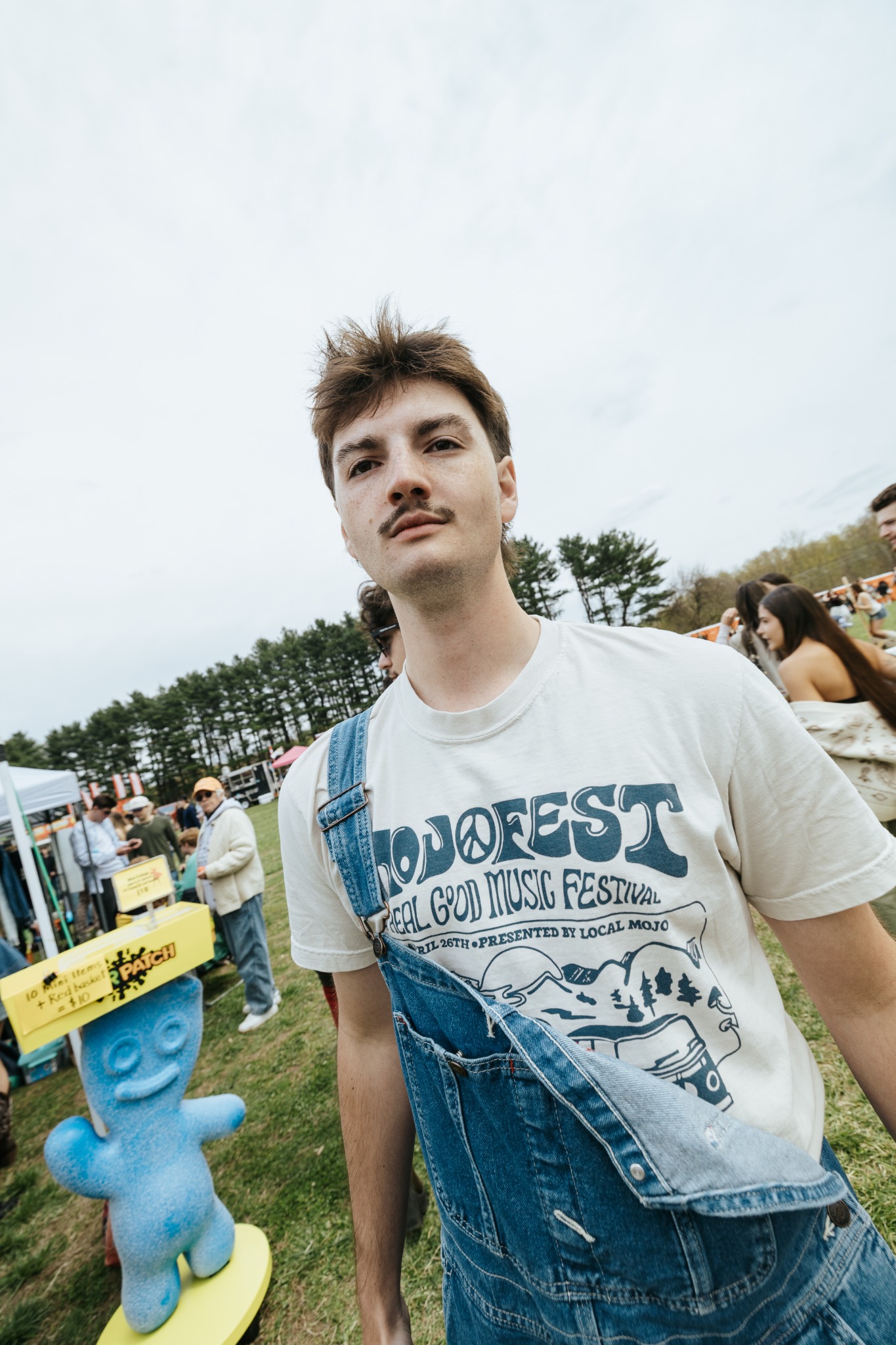 Festivalgoer wearing a printed MOJOFEST shirt in Amherst