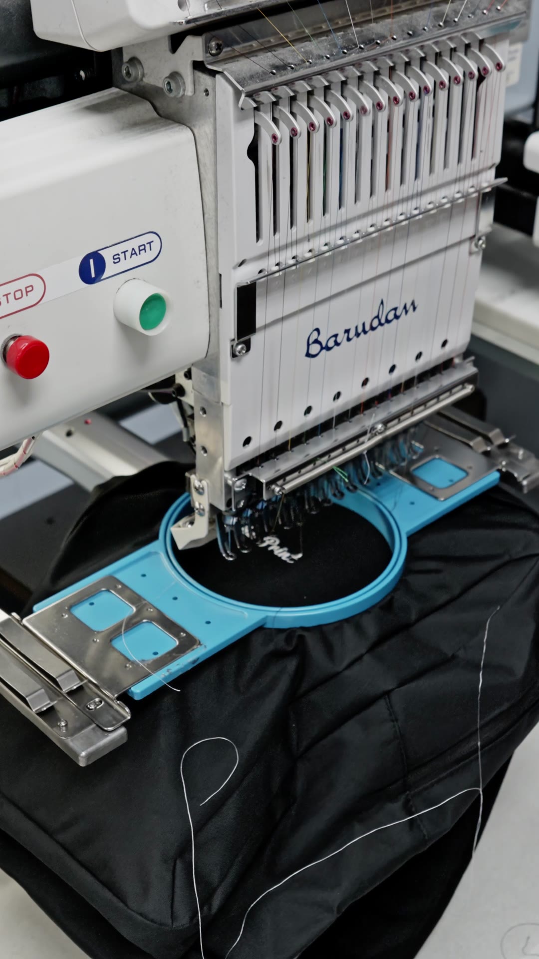 Embroidery machine stitching a garment
