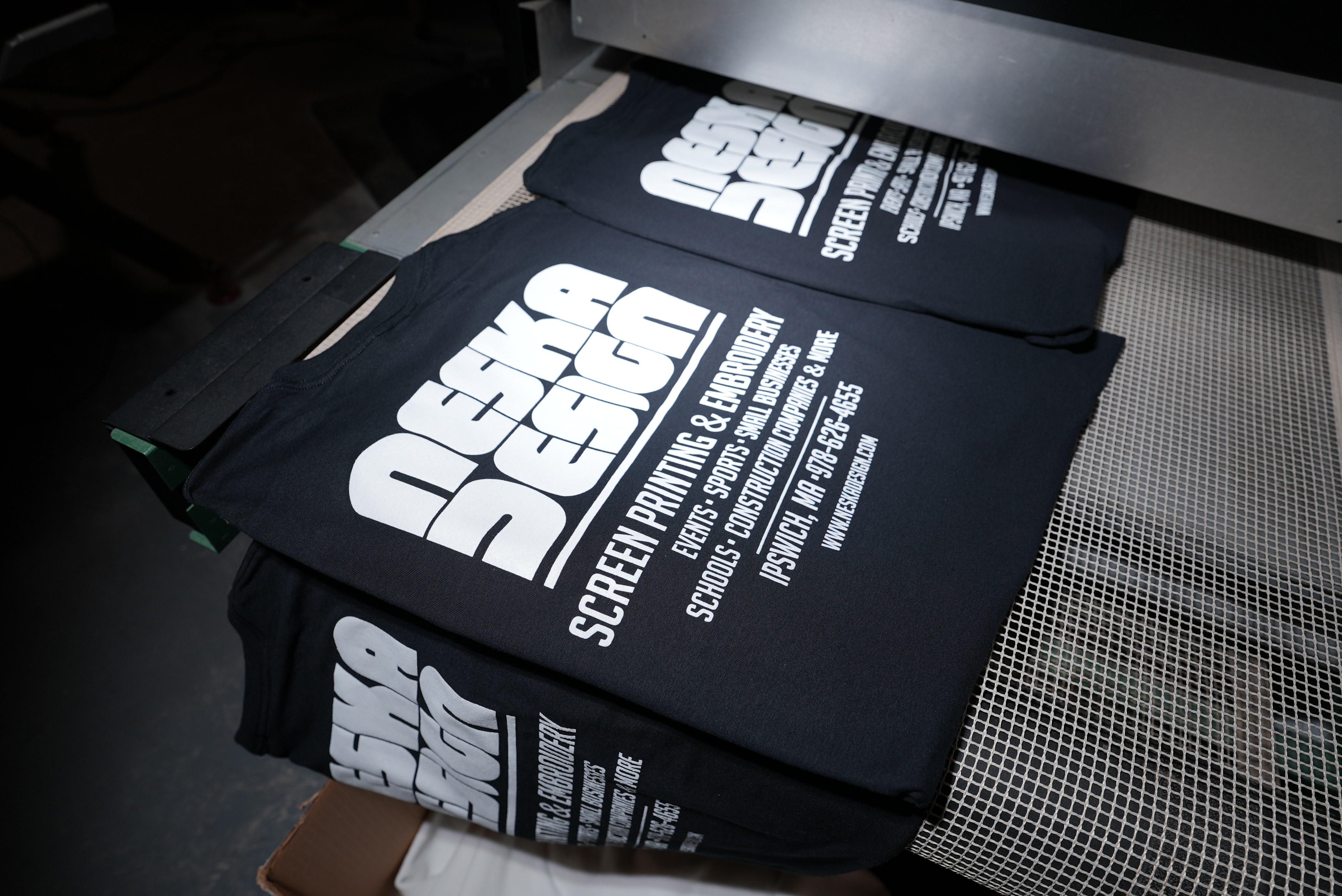 Neska Design shirts on a conveyor dryer